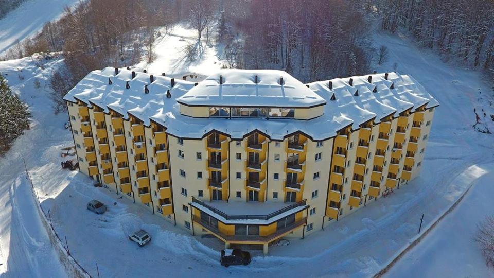 een gebouw met sneeuw erop in de sneeuw bij Apartment Invictus Mavrovo in Mavrovo