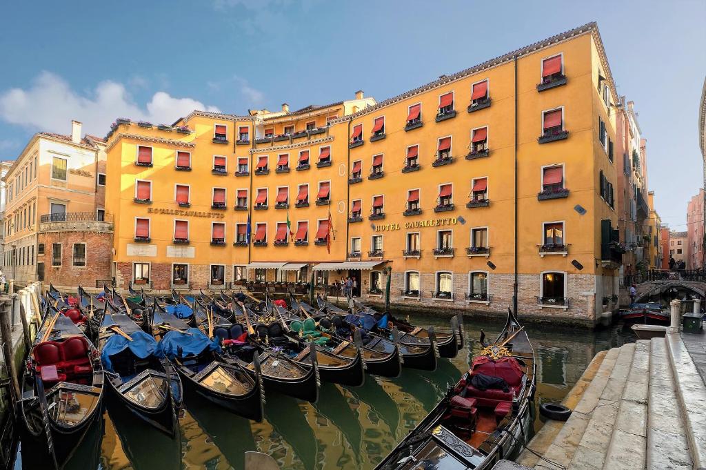 a group of gondolas in the water in front of a building at Albergo Cavalletto &amp; Doge Orseolo in Venice