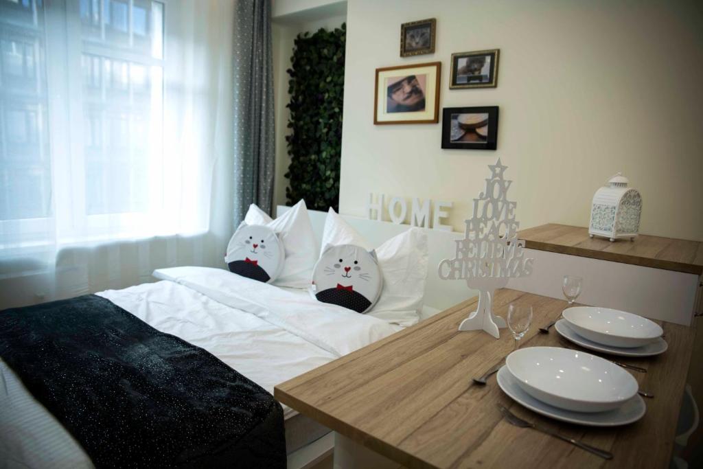 a bedroom with a bed with two cats on it at Amazing Apartment, City Centre, Modern, Elegant, Cozy in Krakow