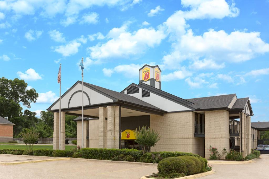 a church with a clock tower on top of it at Super 8 by Wyndham Ruston in Ruston