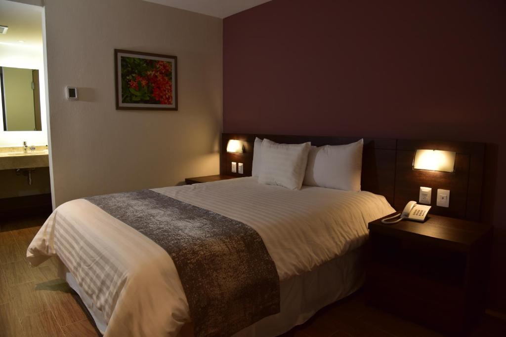Postel nebo postele na pokoji v ubytování Lithio Hotel