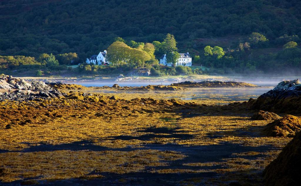 a house on the shore of a body of water at Kinloch Lodge Hotel and Restaurant in Kinloch