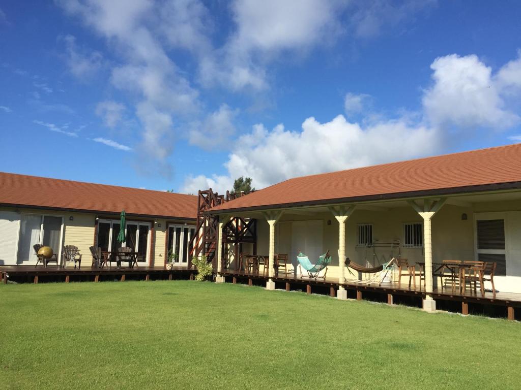 a building with a large lawn in front of it at guest house annsea in Ishigaki Island