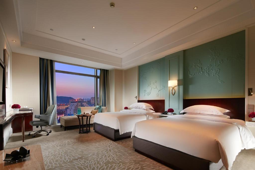 Postel nebo postele na pokoji v ubytování Wen Ling International Hotel