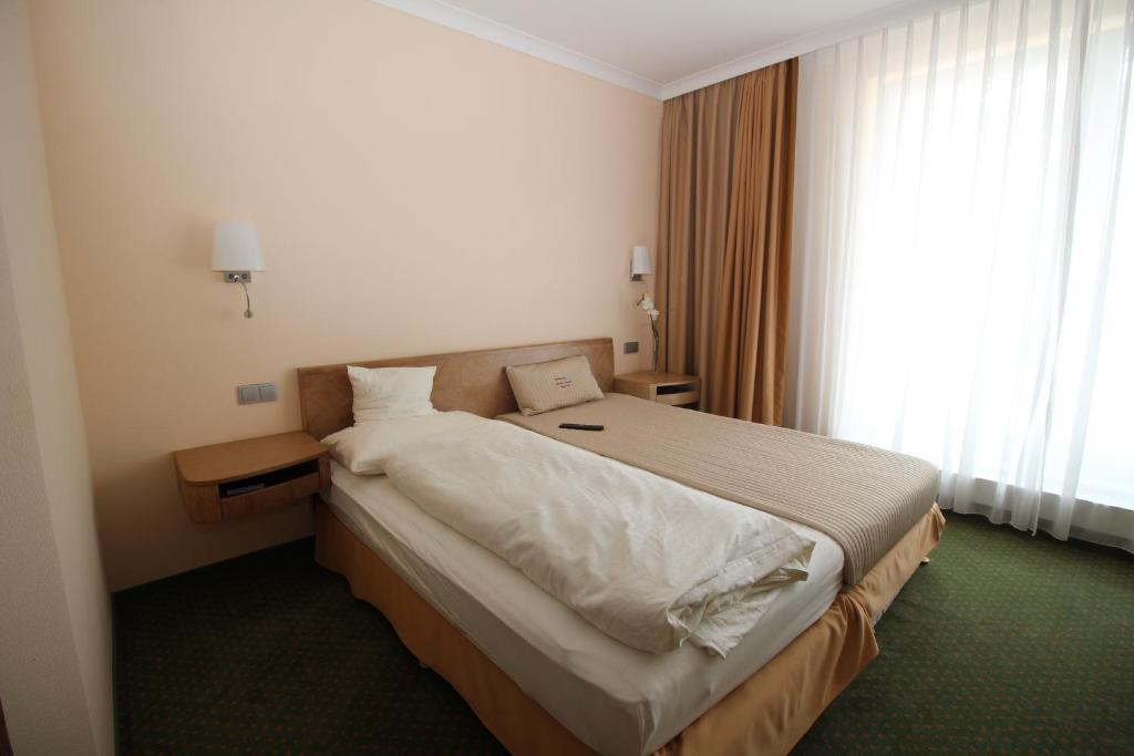 Postel nebo postele na pokoji v ubytování Lindemann Hotel