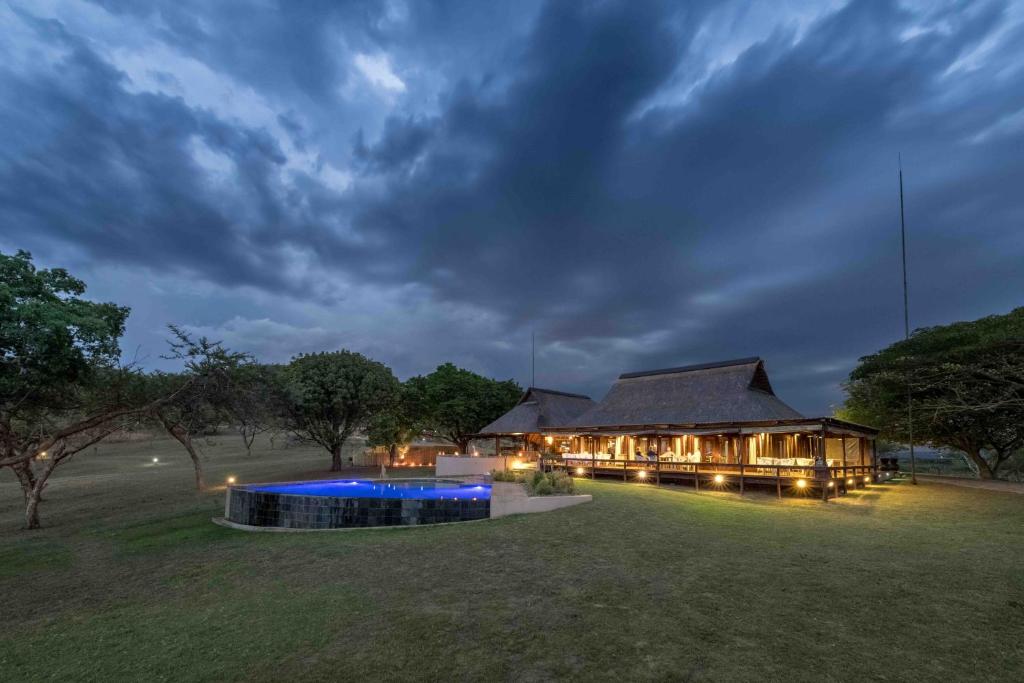 a house with a large yard at night at Muluwa Lodge in White River