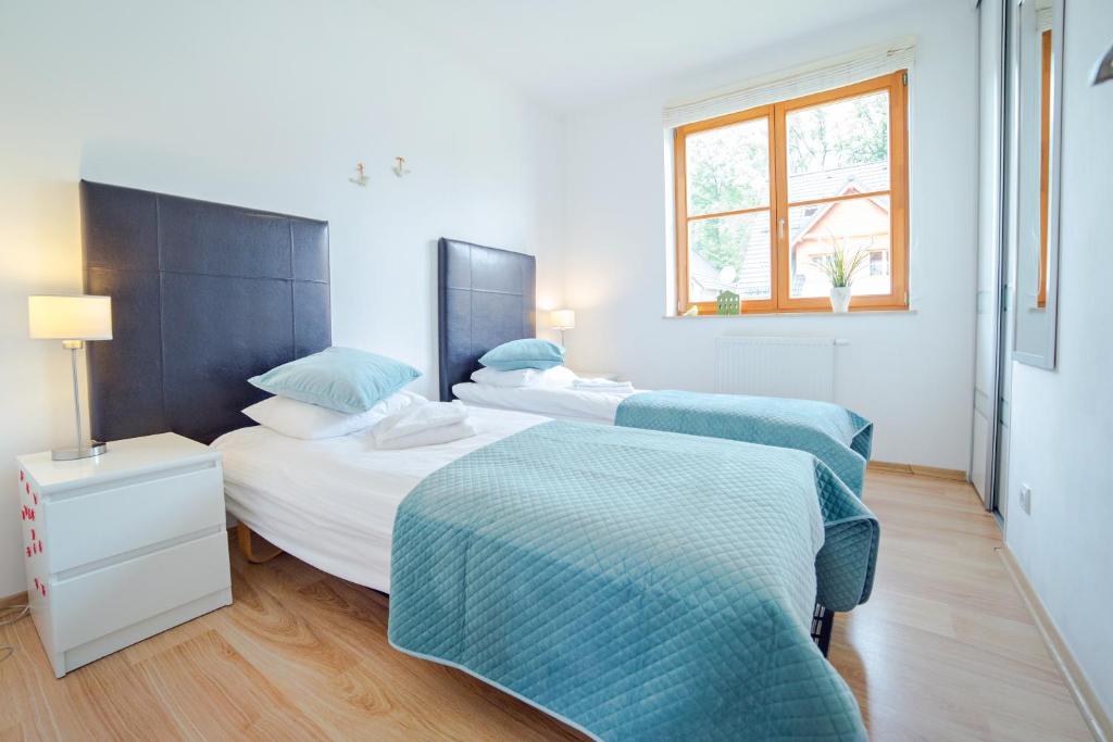Posteľ alebo postele v izbe v ubytovaní Apartamenty Sun & Snow Karpacz Myśliwska