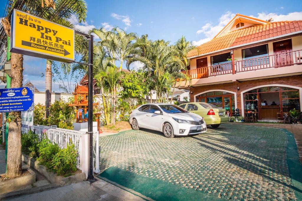 a white car parked in front of a house at Happy in Pai in Pai