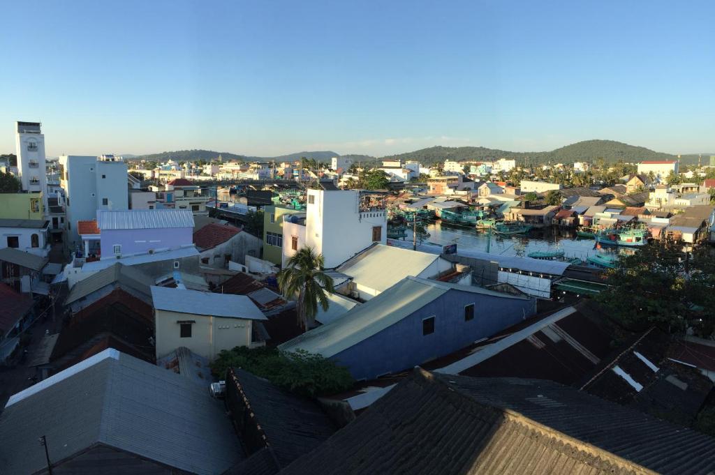 a view of a city with buildings and a harbor at Ngan Giang Guesthouse in Phú Quốc