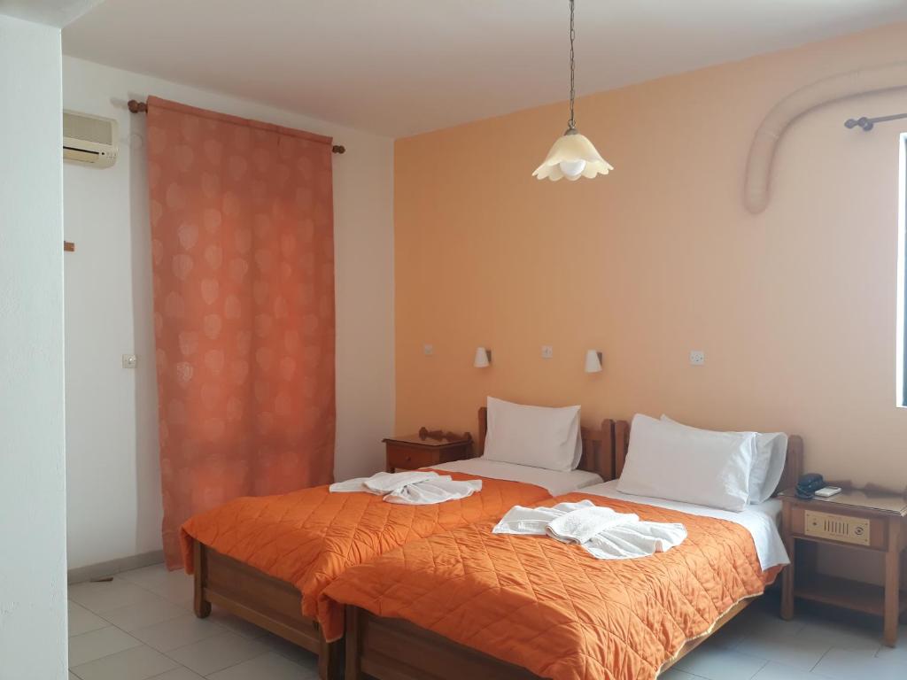 a bedroom with a bed with towels on it at Amaryllis Hotel in Karpathos
