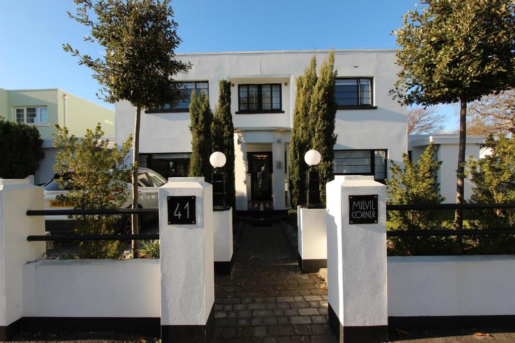 a white house with two mailboxes in front of it at Milvil in Gosport