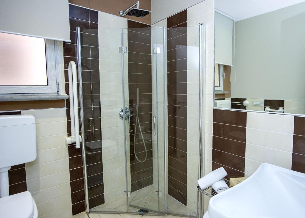 a bathroom with a shower and a toilet at Hotel C'era Una Volta in Castiglione della Pescaia