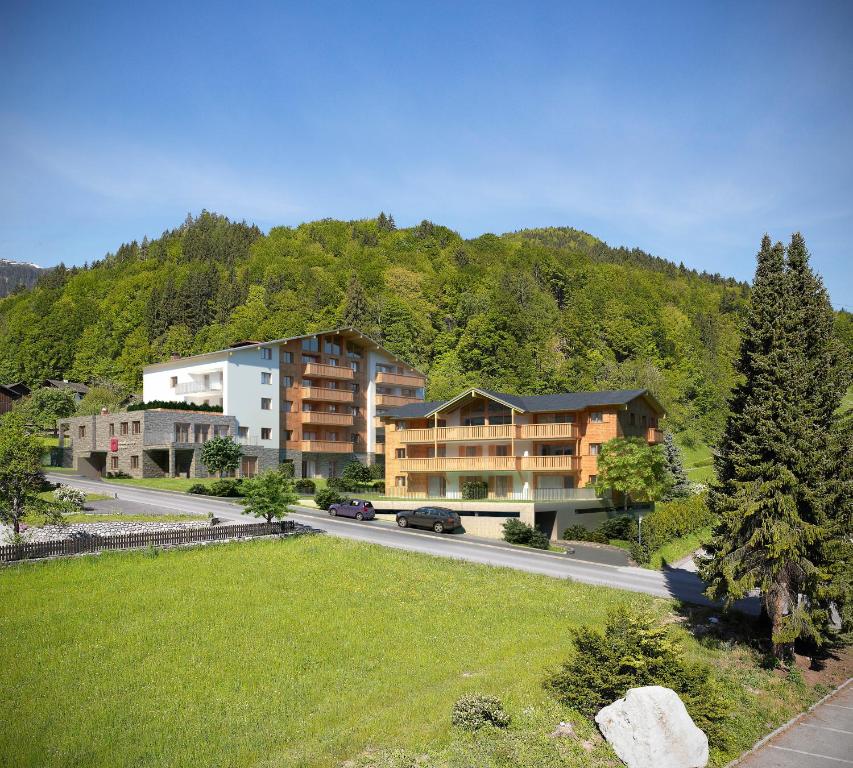 a large apartment building on a road in the mountains at Verwall Apartment in Schruns-Tschagguns