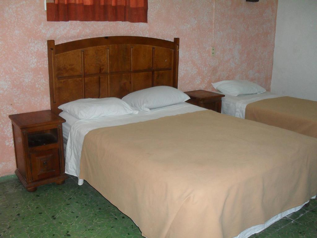 Postel nebo postele na pokoji v ubytování Hotel San Jose