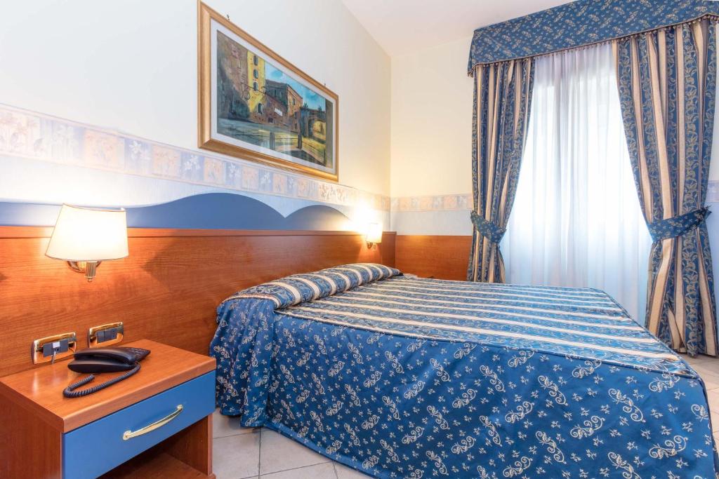 Postel nebo postele na pokoji v ubytování Hotel Borgo Del Mare