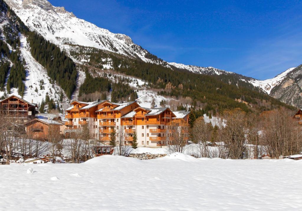 a hotel in the mountains with snow on the ground at Résidence Goélia Le Blanchot in Pralognan-la-Vanoise