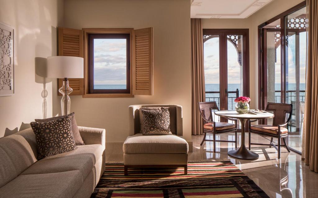a living room with a couch and a table at Four Seasons Hotel Tunis in Gammarth