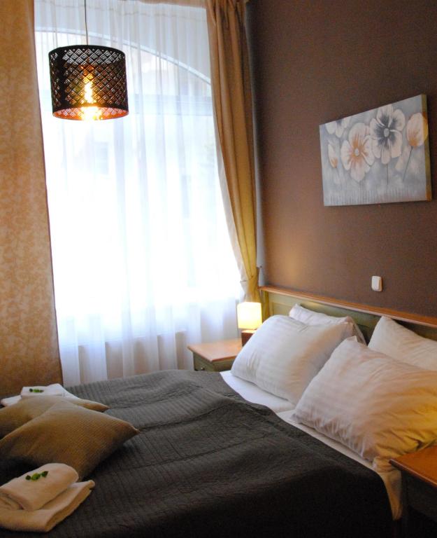 Postel nebo postele na pokoji v ubytování Hotel Augustus et Otto