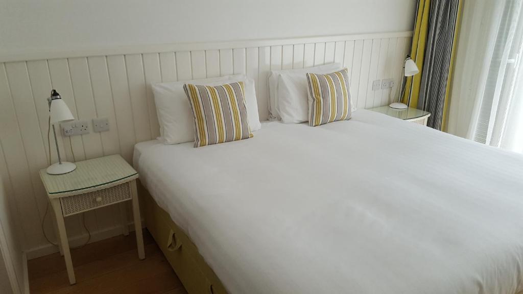 a large white bed in a room with a window at Bridge of Orchy Hotel in Bridge of Orchy