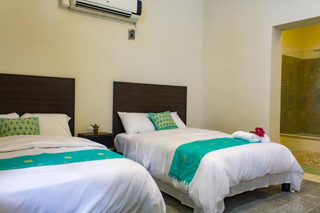 Postel nebo postele na pokoji v ubytování Hotel Maculís