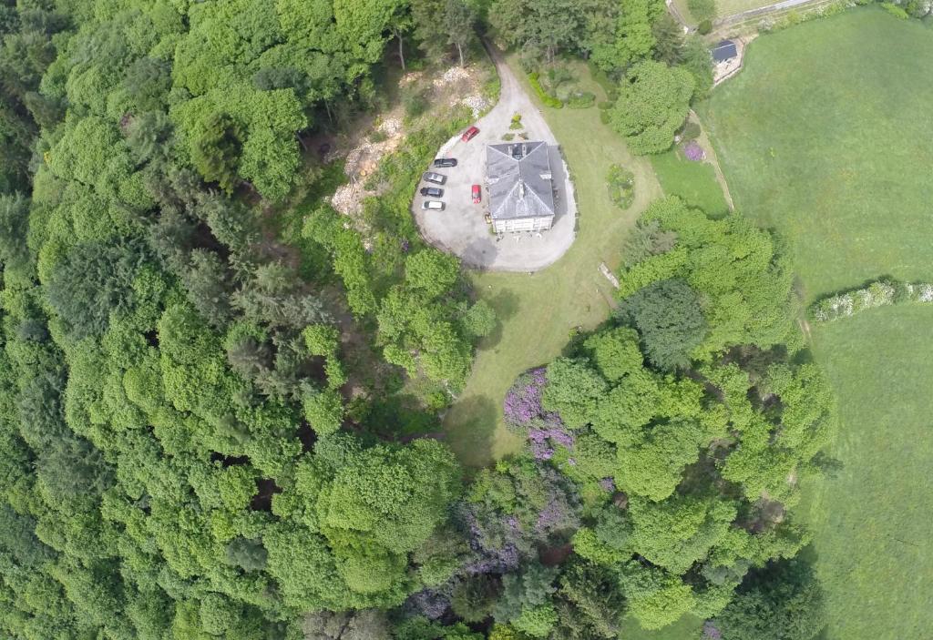 an aerial view of a house in the middle of a forest at Chateau de Beaulieu in Saint-Sauveur-le-Vicomte