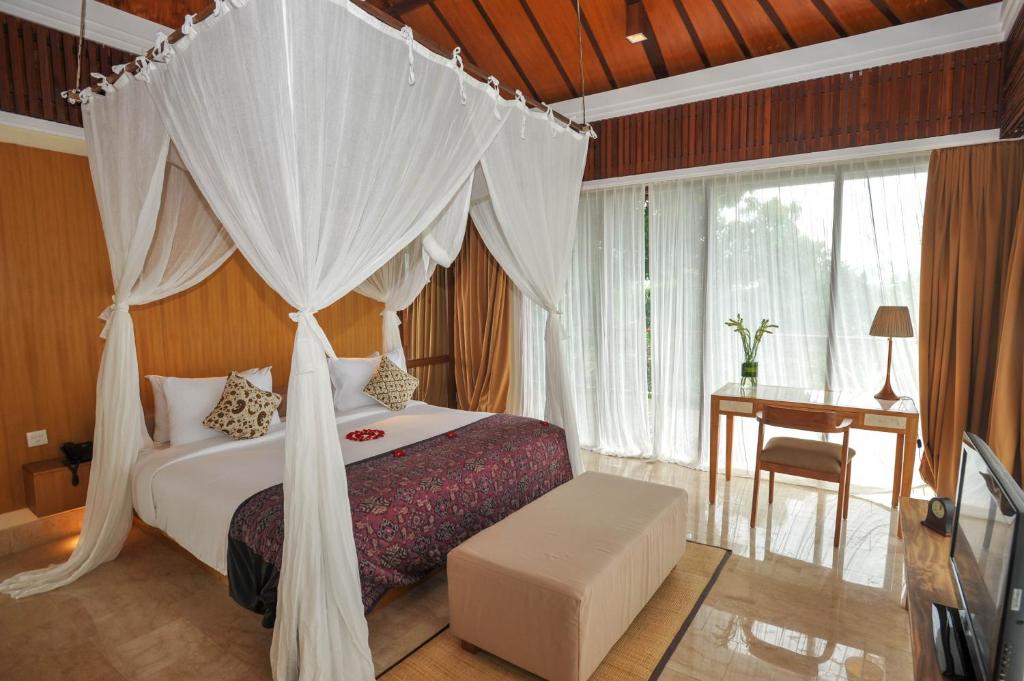 Postel nebo postele na pokoji v ubytování Komaneka at Rasa Sayang Ubud