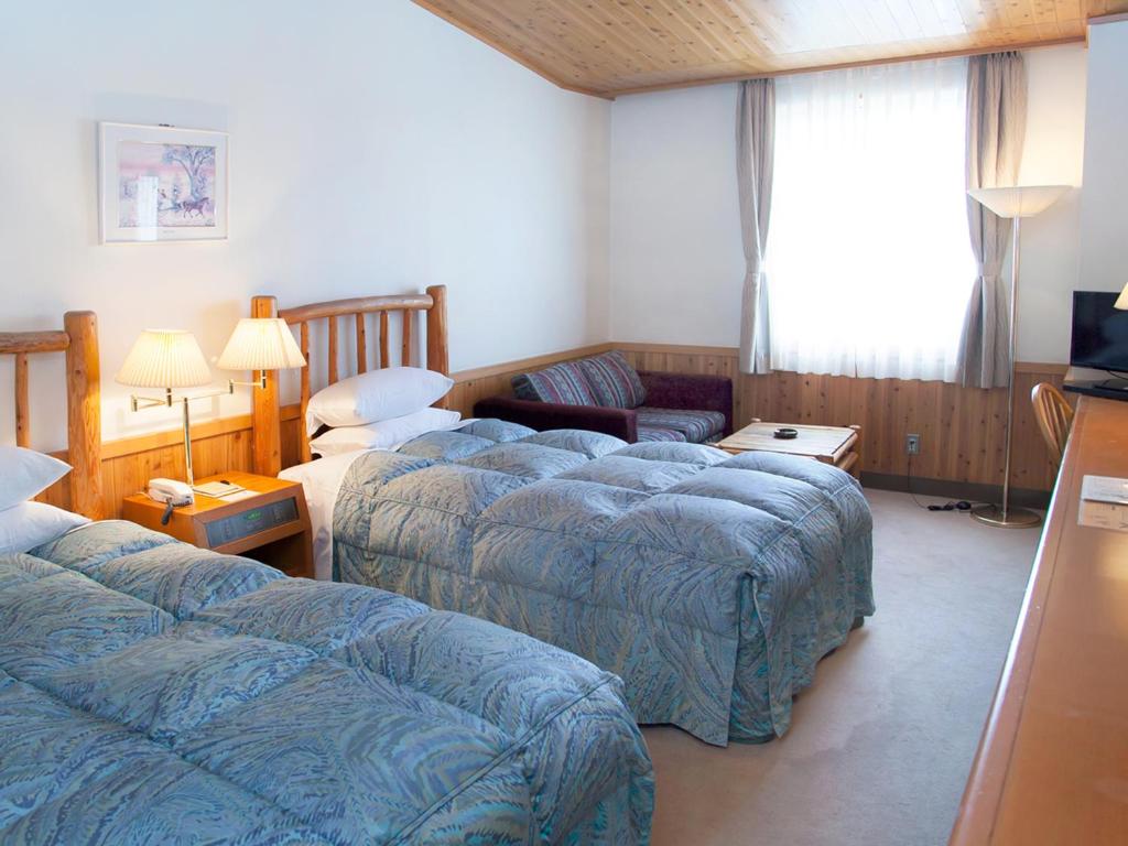 Postel nebo postele na pokoji v ubytování Kibi Kogen Resort Hotel