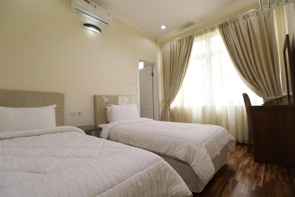 Postel nebo postele na pokoji v ubytování Diyar Villas Puncak NB3/3