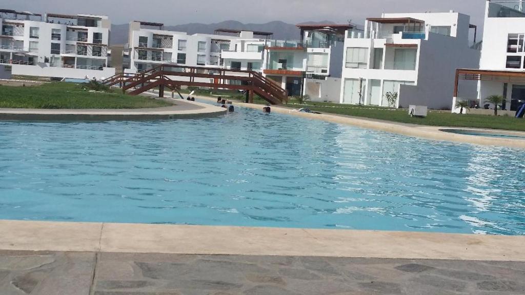 a large swimming pool in front of some apartment buildings at Condominio Las Terrazas in Asia