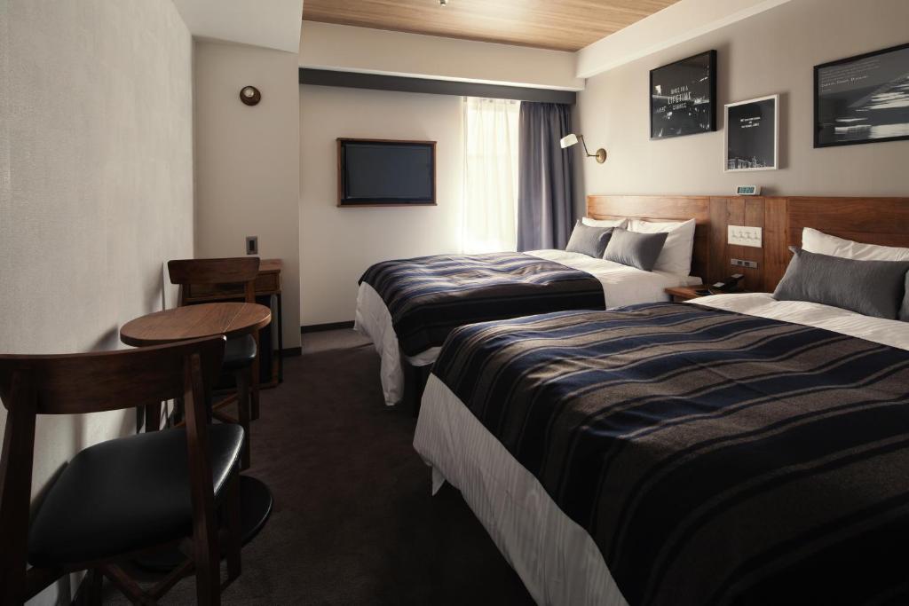 Postel nebo postele na pokoji v ubytování Hotel The Knot Yokohama