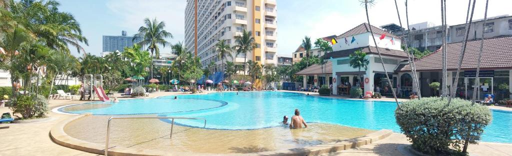 a large swimming pool with people in the water at View Talay 1B Pattaya Jomtien in Pattaya South