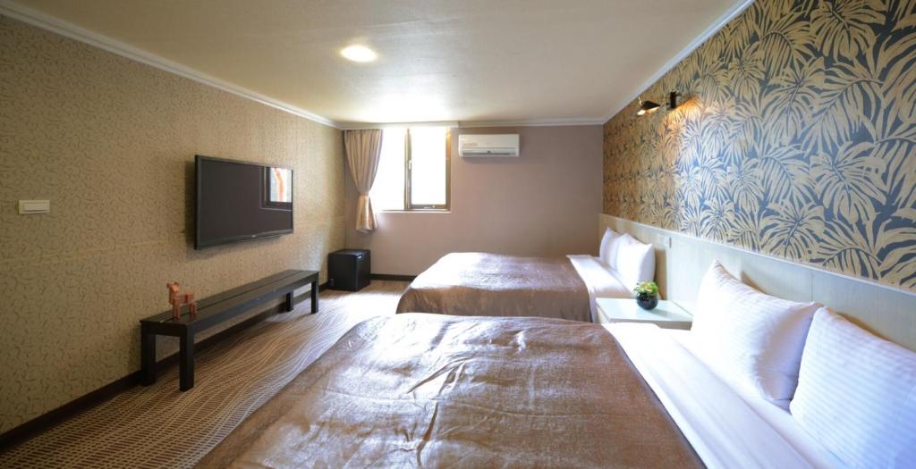 Postel nebo postele na pokoji v ubytování Ximen Hotel