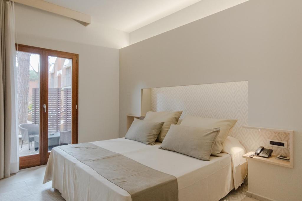 Een bed of bedden in een kamer bij Hotel Corte Rosada