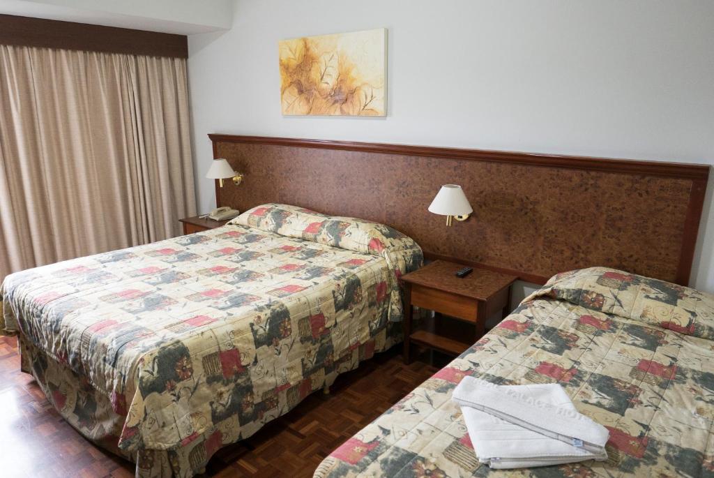 Postel nebo postele na pokoji v ubytování Real Palace Hotel