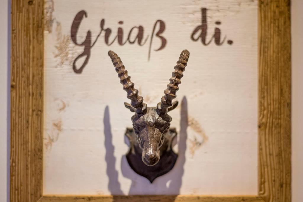 a picture of an animal with horns on a wall at Haus Central in Kössen