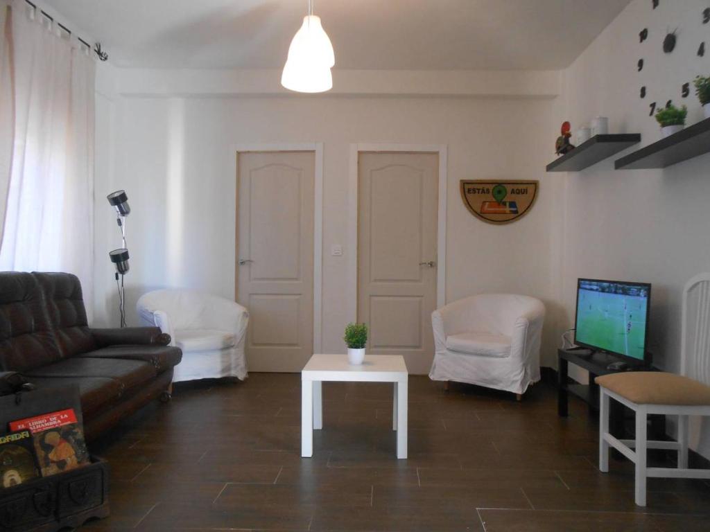 a living room with a couch and a table at Apartamento Catedral Centro in Granada