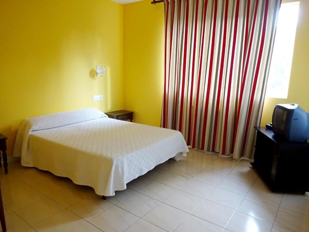 Postel nebo postele na pokoji v ubytování Hotel Millan