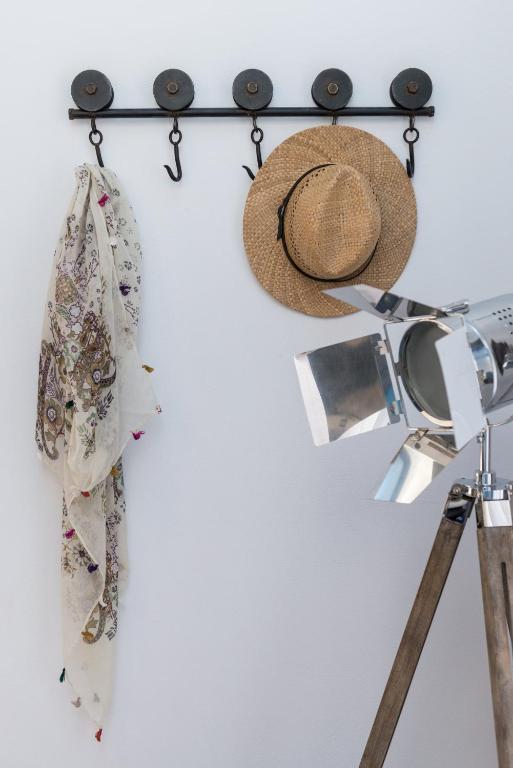 a hat and a wand hanging on a wall at Kaerati Apartments in Katapola