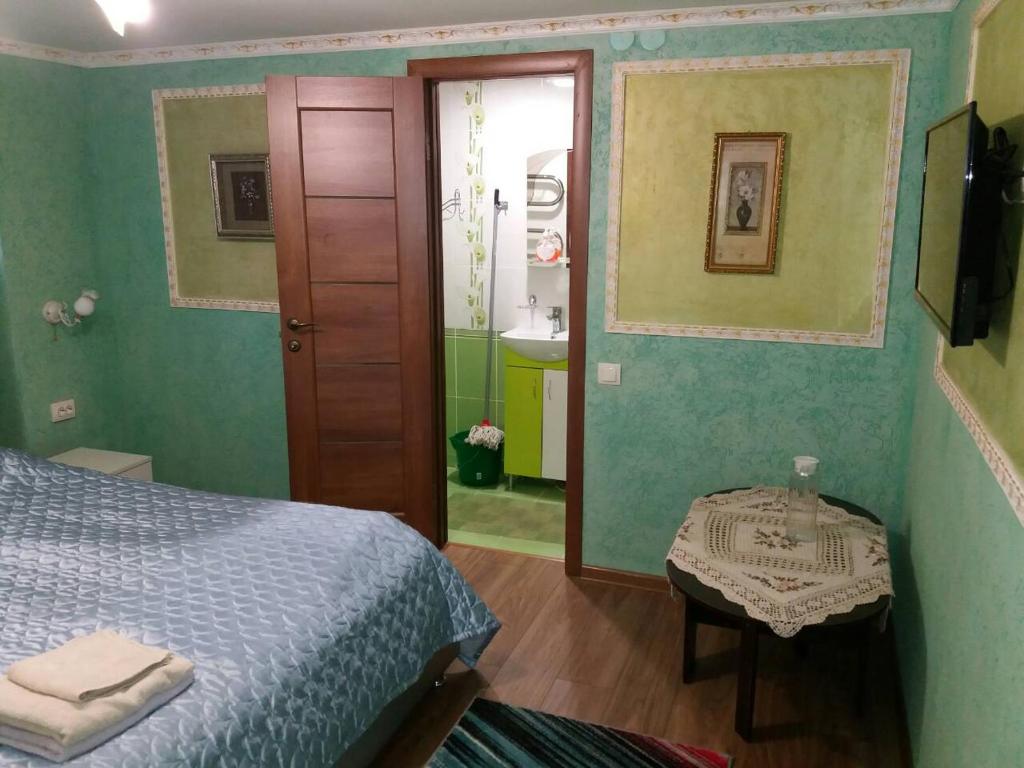 Postel nebo postele na pokoji v ubytování Guest House Zhanna