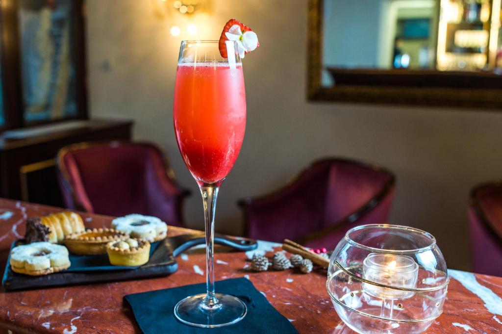 a drink in a glass sitting on a table at Hotel Nani Mocenigo Palace in Venice