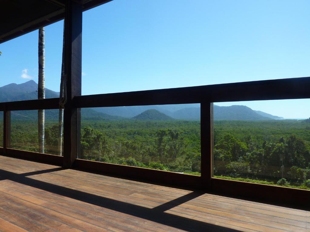 a room with a view of the mountains through windows at Daintree Holiday Homes - La Vista in Cow Bay