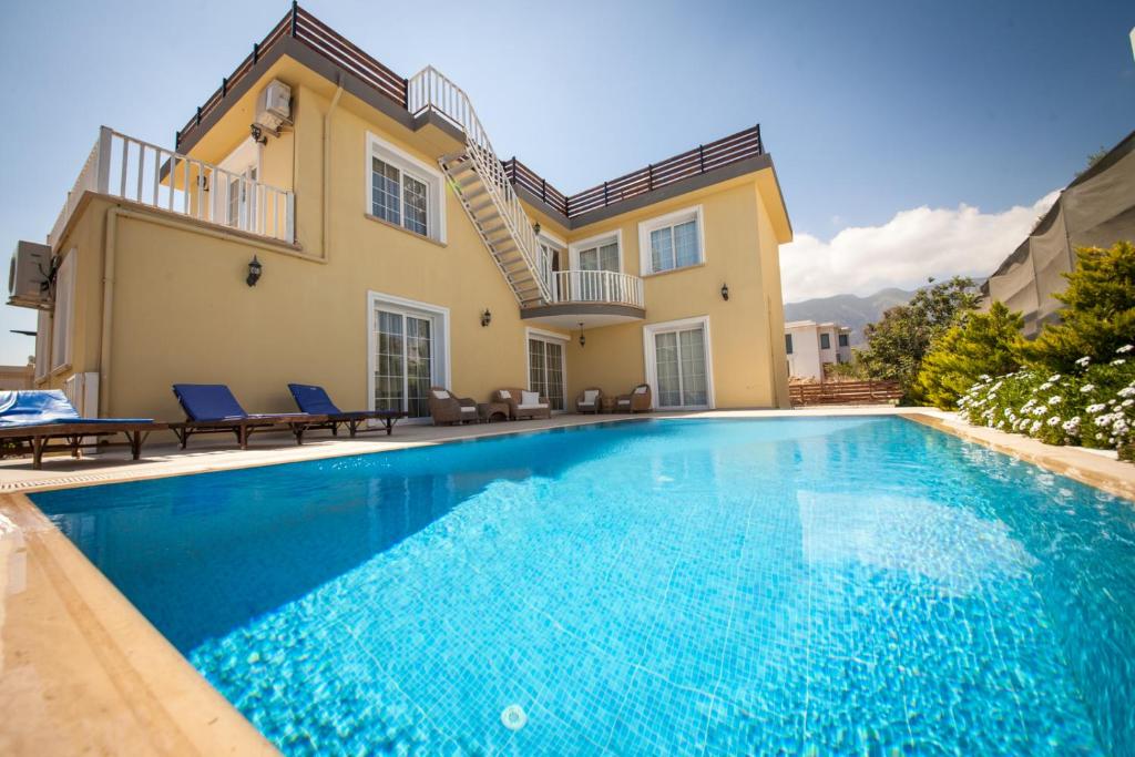 a swimming pool in front of a house at Villa Daria in Kyrenia