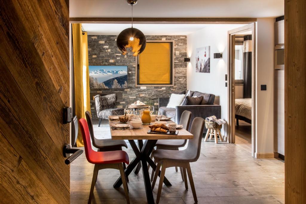 a dining room with a table and chairs at Montana Lodge in Val Thorens