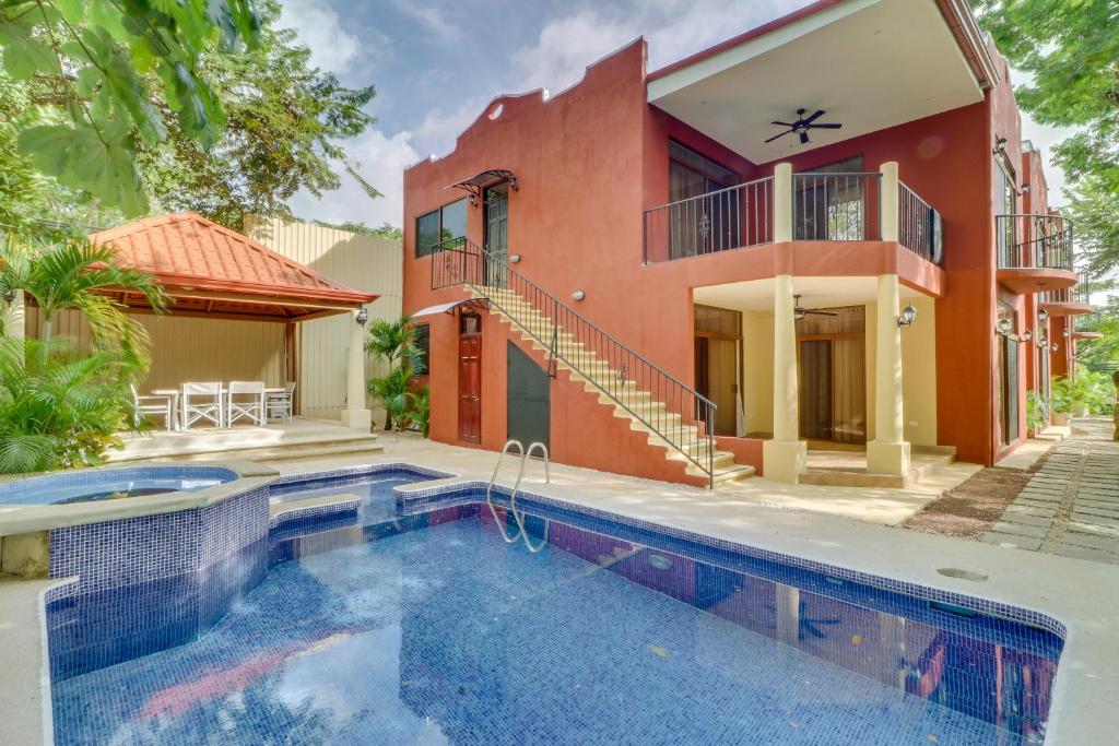 a house with a swimming pool in front of a house at Brisas del Monte #3 in Guanacaste