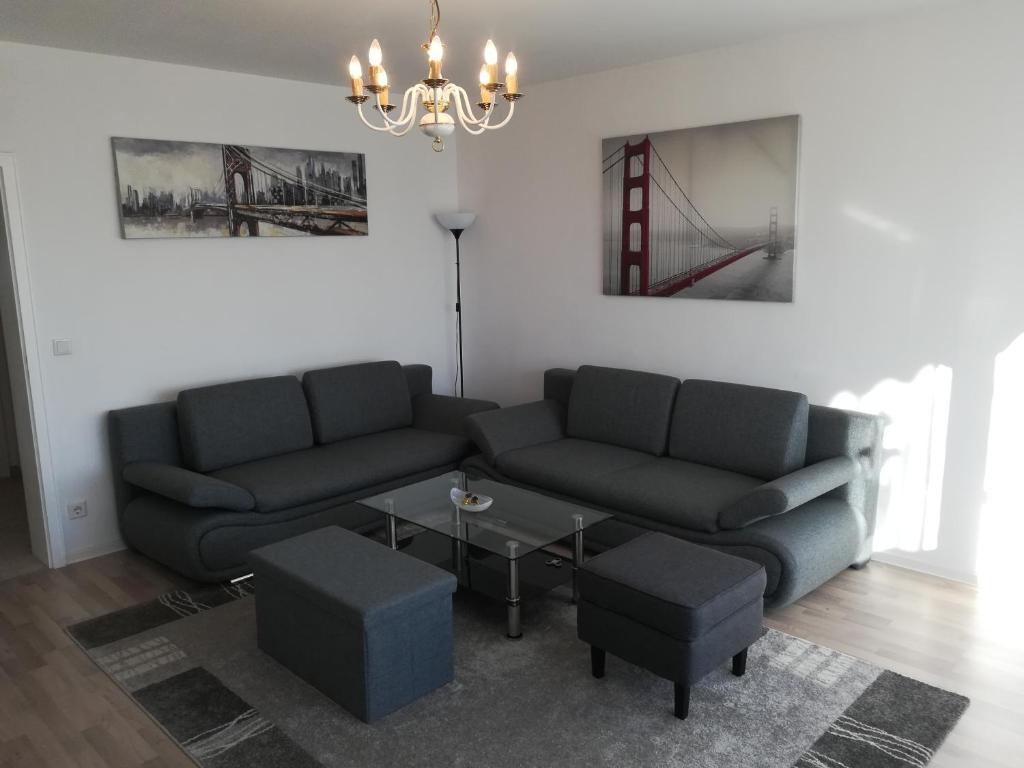 a living room with a couch and a table at Ferien - und Messewohnung am Stadtpark in Nuremberg