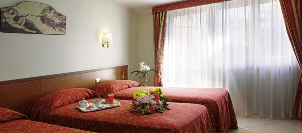 Postel nebo postele na pokoji v ubytování Hotel Vitti