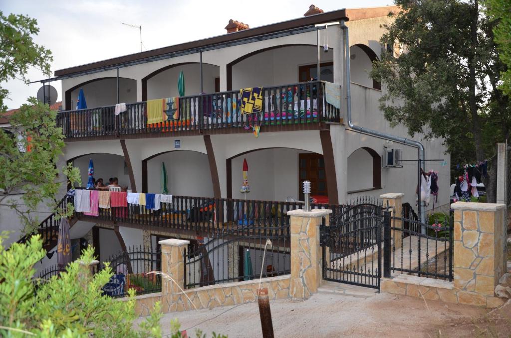 a building with clothes drying on a balcony at Apartments Delfin in Posedarje