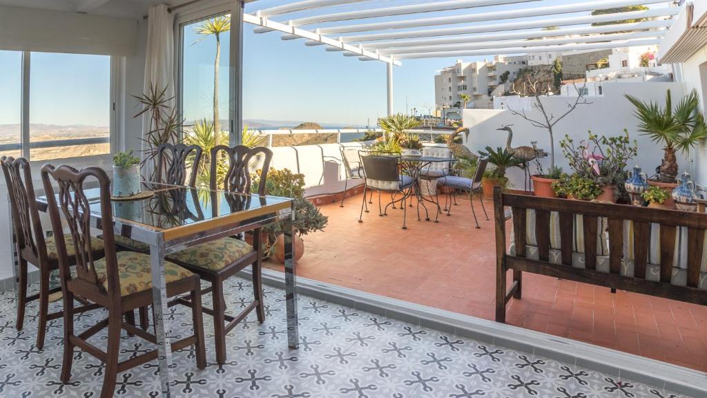 a patio with a table and chairs on a balcony at Casa Alta Mojacar Pueblo in Mojácar