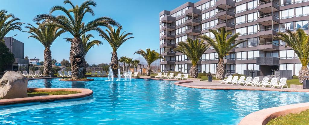 a large pool of water in front of a large building at Hotel Club La Serena in La Serena