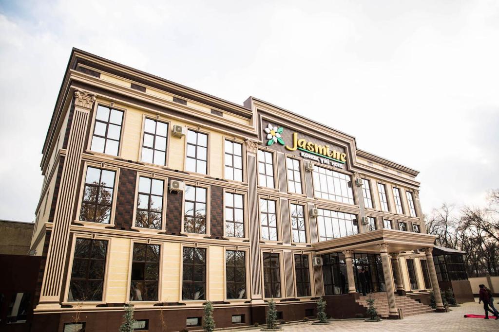 a large building with a sign on top of it at Jasmine in Taraz